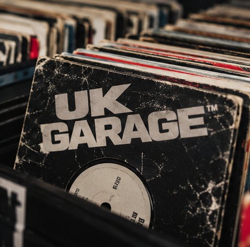 A worn record sleeve printed UK Garage, standing in a crate of vinyl.
